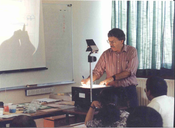 David Hulme presenting a lecture in 1994
