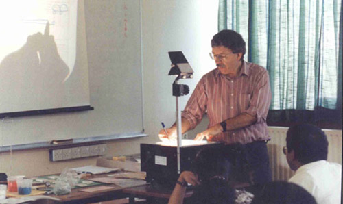 David Hulme presenting a lecture in 1994