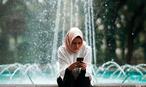 A woman looks at her mobile phone in Menteng, Central Jakarta City, Jakarta, Indonesia