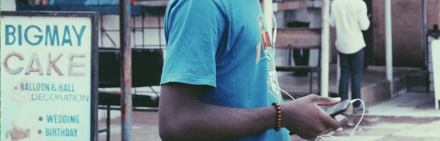 A teenager using his phone in Nigeria