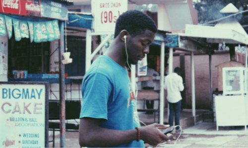 Teenager using his phone at Ahmadu Bello University, Zaria, Kaduna, Nigeria