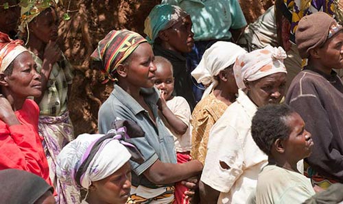 Women and children attending or staring at something off camera