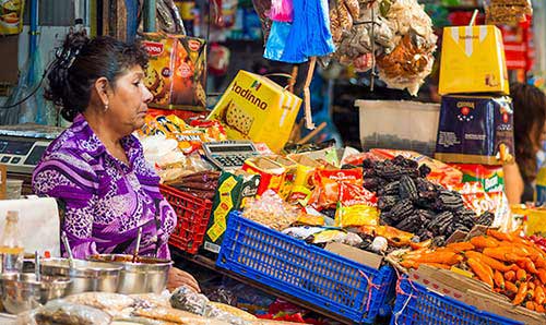 Woman looking at brightly coloured market produce