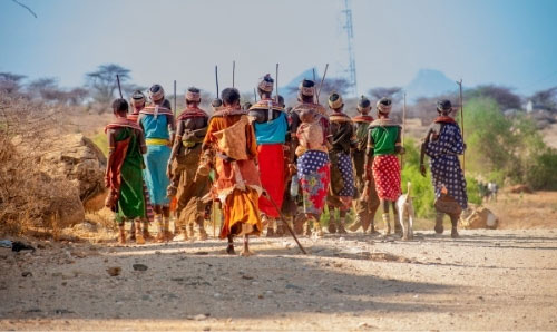 A group of Kenyan farmers with their backs to camera