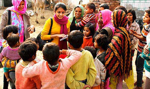 Young woman carrying out interviews with a crowd of people