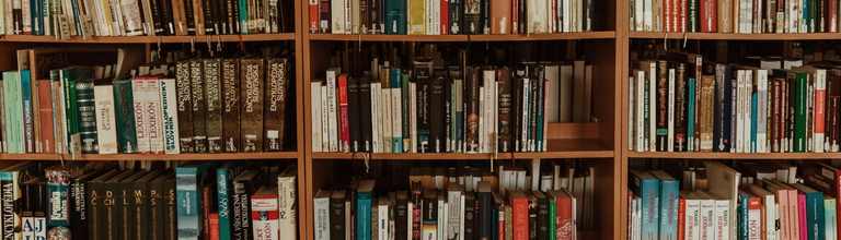 A book shelf containing journals and books