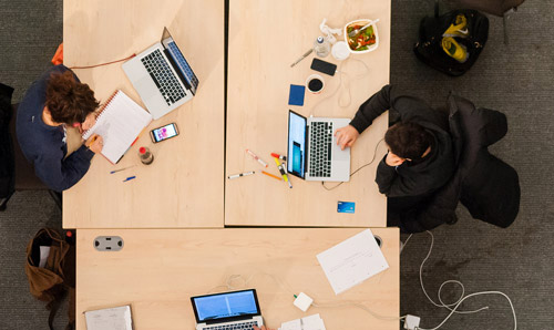 PhD students using computers, photo taken from above